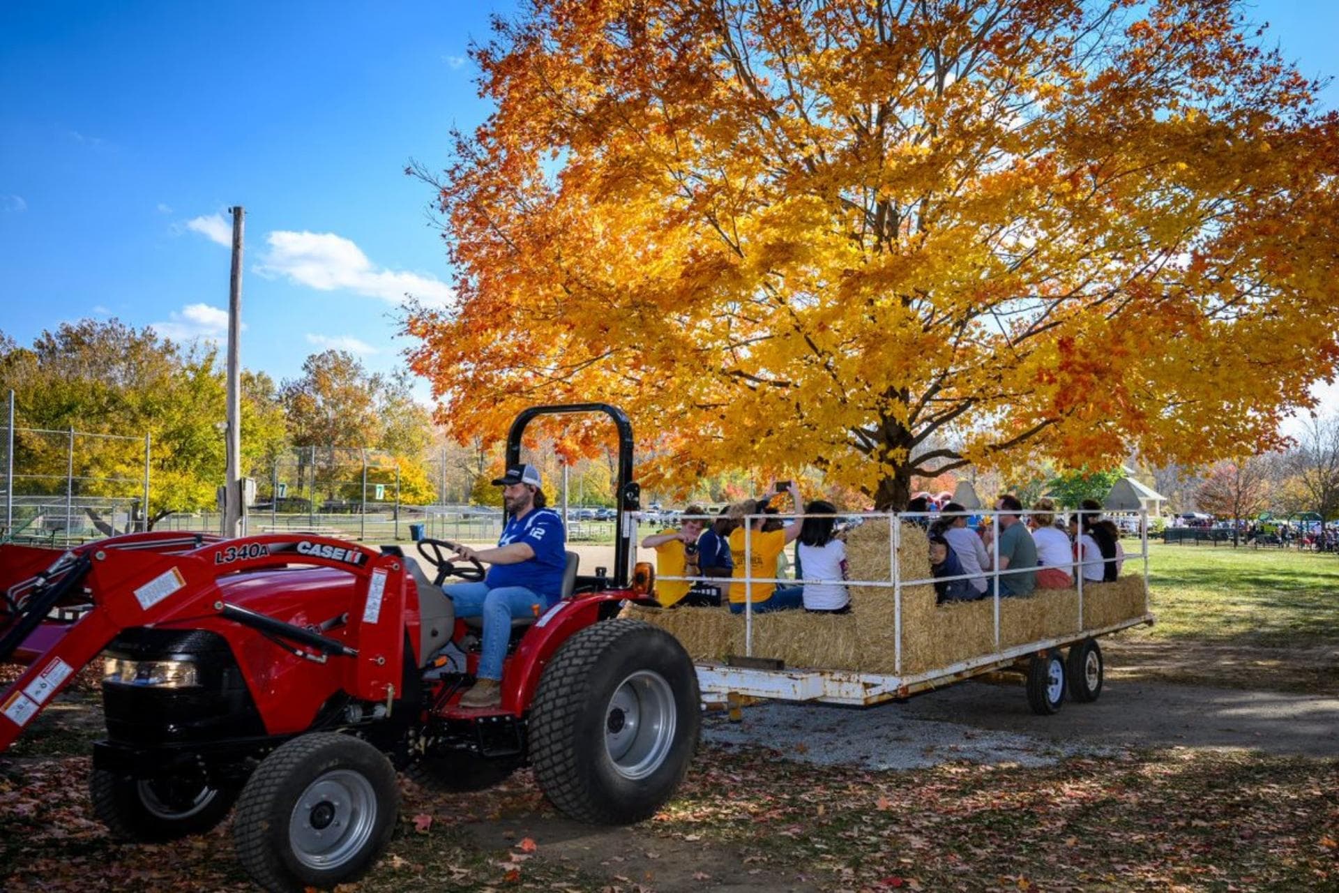 Families enjoying a hayride and pumpkins at Lions Park in Zionsville in fall