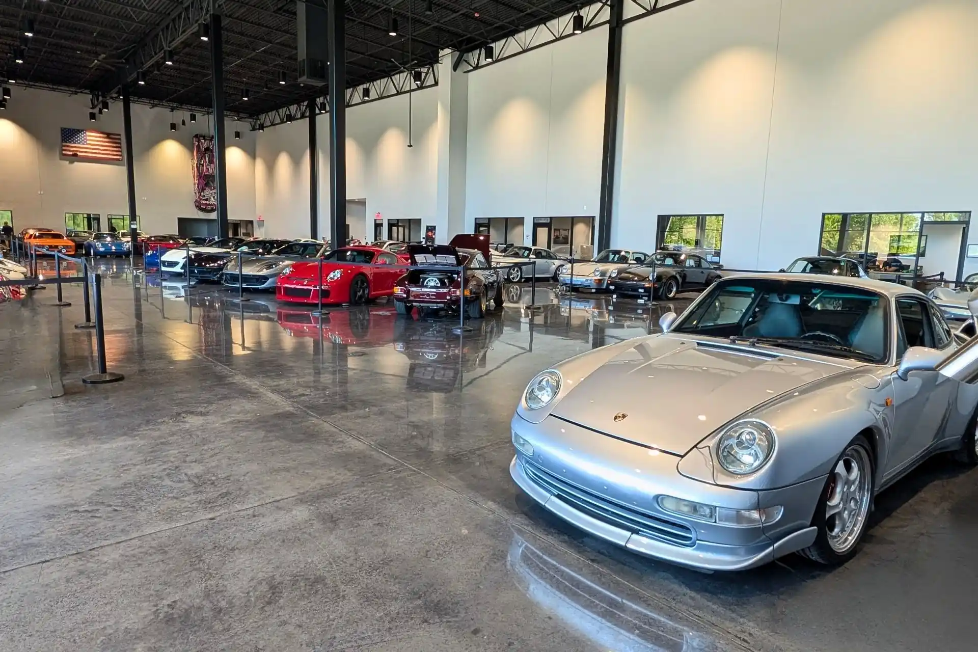Cars from different eras displayed outside Graham Rahal Performance during Cars & Coffee in Zionsville.