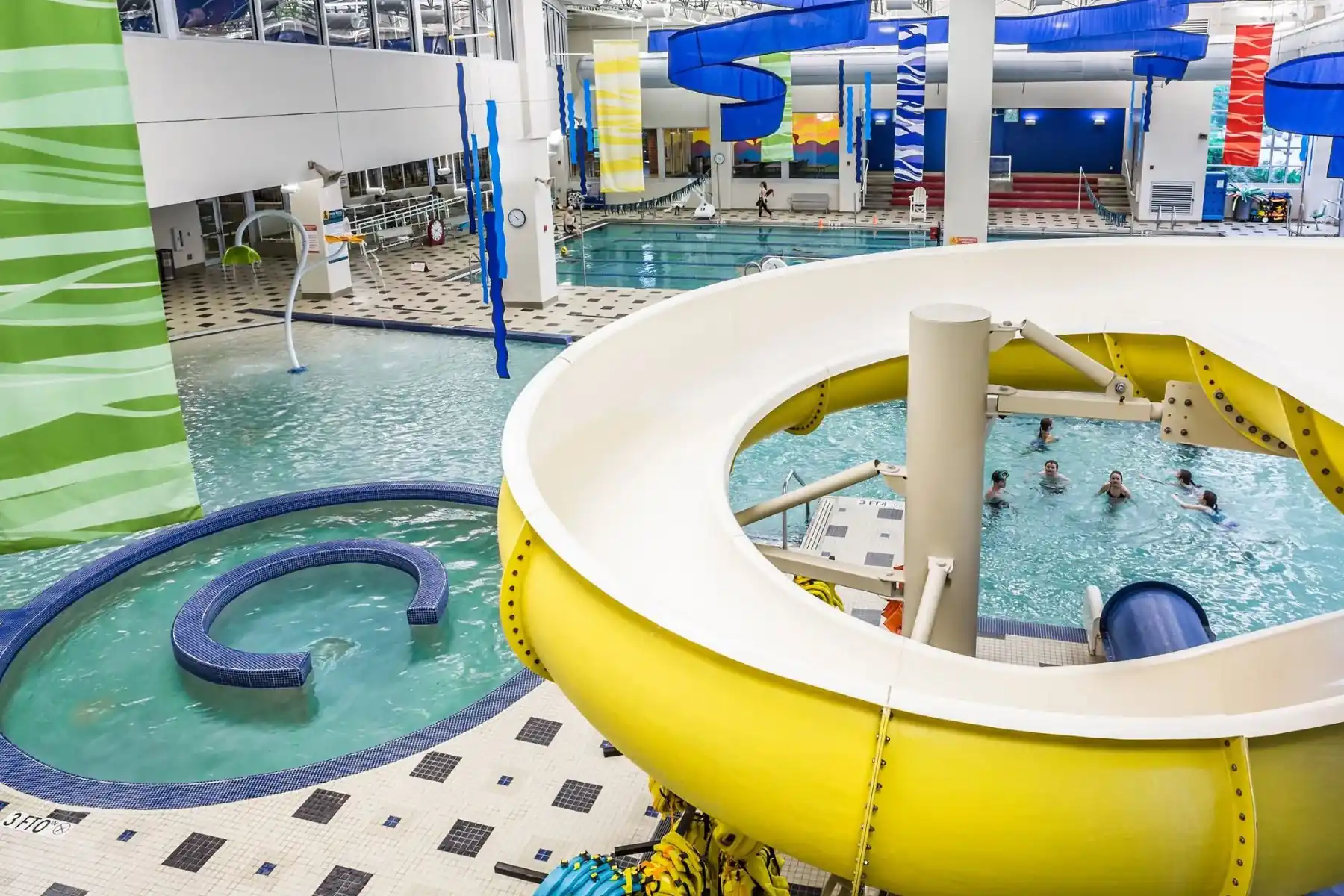 Monon Community Center indoor pool in Carmel with water slide features, shallow play areas, and swim lanes for kids.