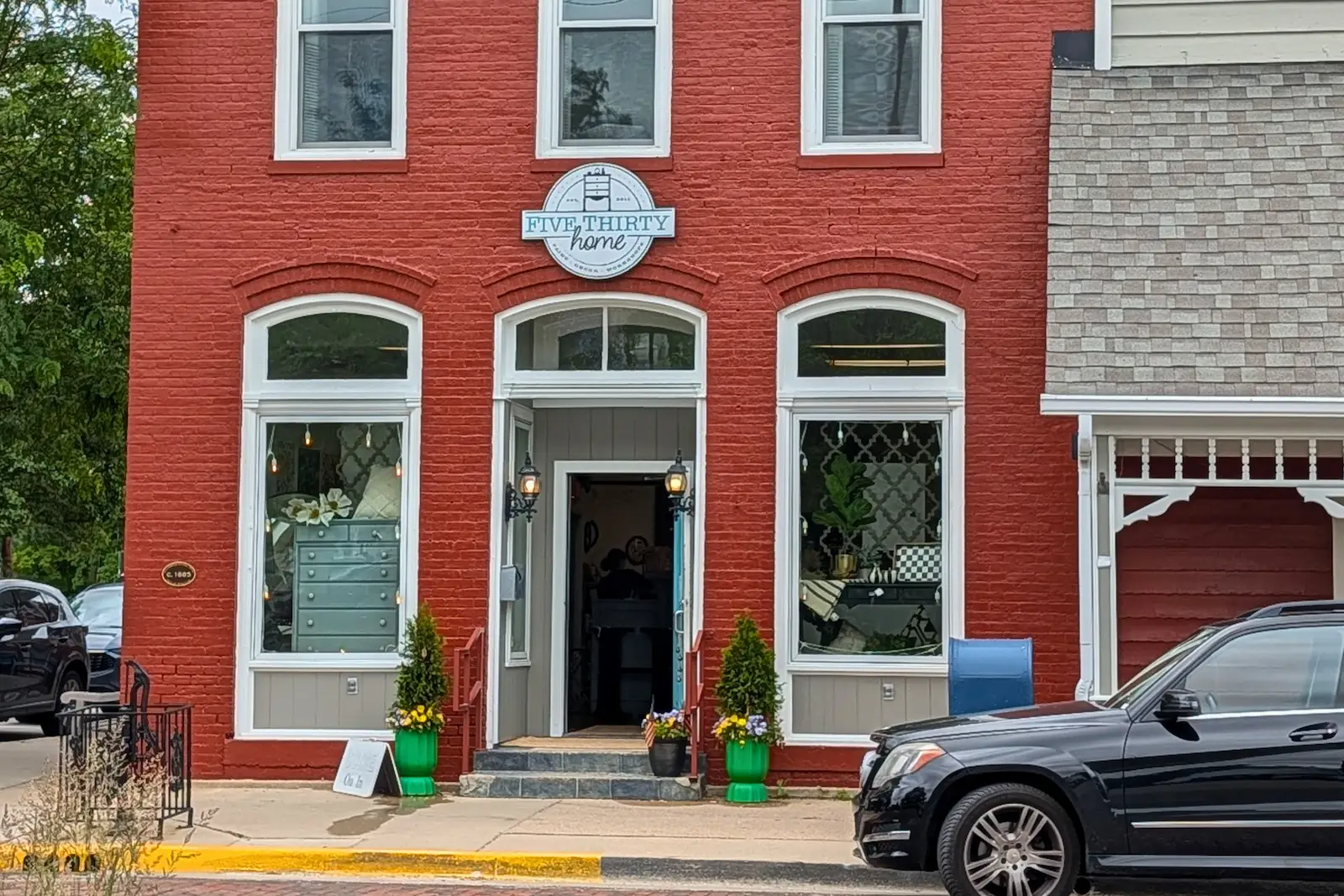 The historic red brick exterior and front entrance of Fivethirty Home décor and furniture shop on South Main Street in downtown Zionsville.