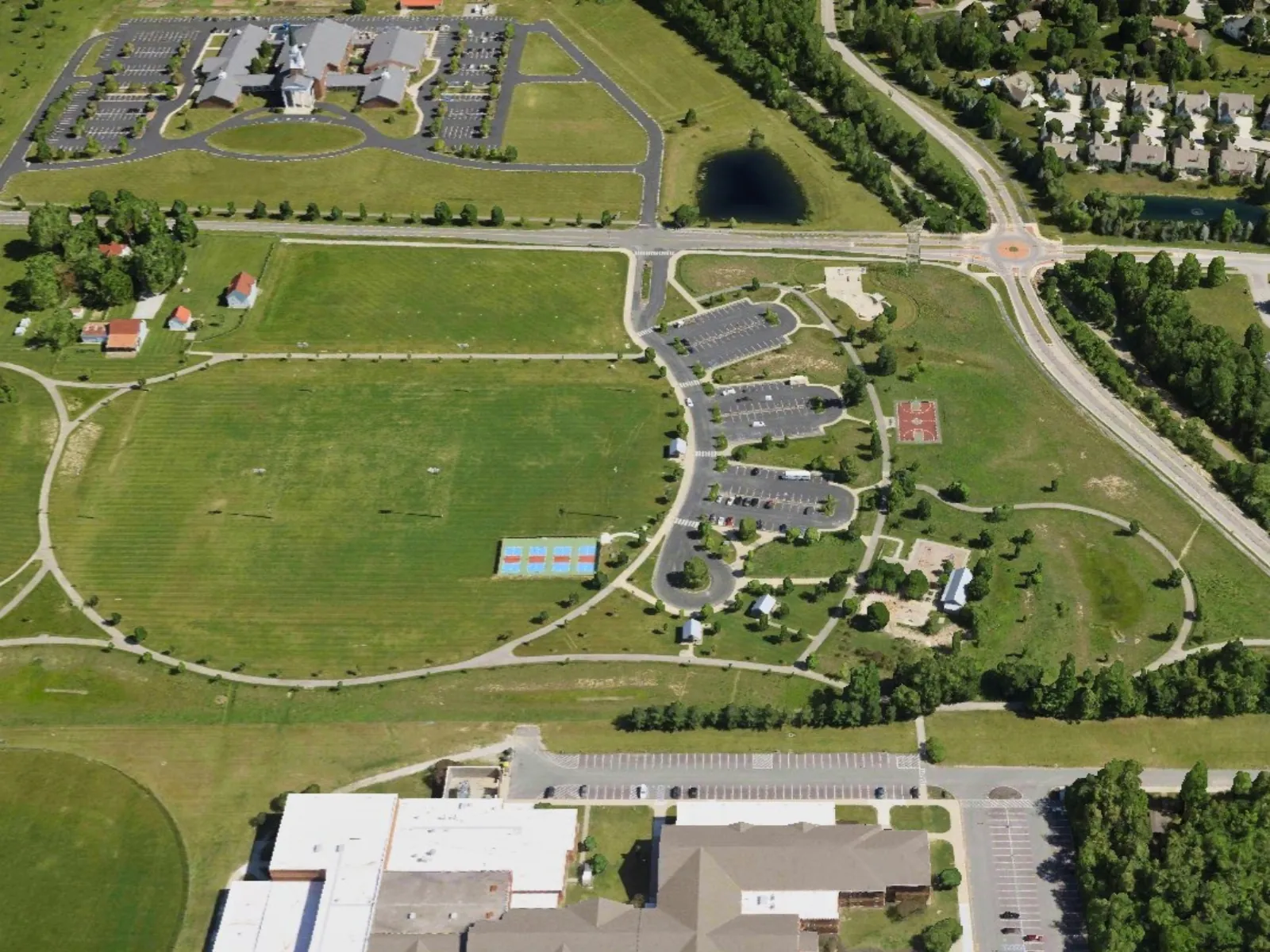 Aerial view of Mulberry Fields Park in Zionsville, Indiana showing on-site parking and overflow parking nearby.