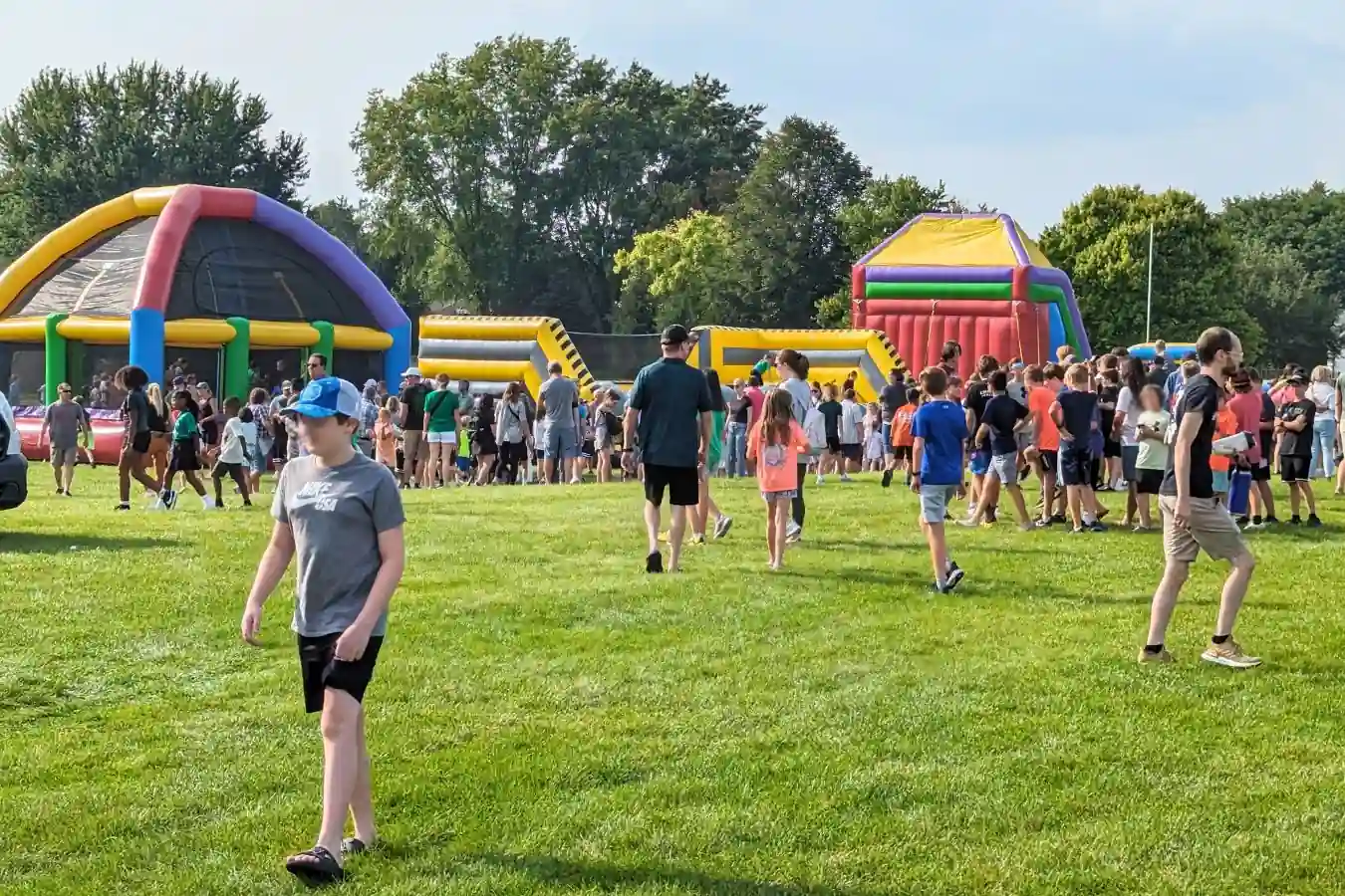Inflatable bounce houses and obstacle courses on Jennings Field during Eagle Fest in Zionsville.